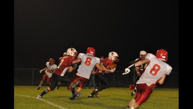 Junior Jacob Hong (center, with football) picked off a Colfax pass for the Cards’ second interception of the game.