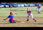 Shortstop Abbey Graner takes the pickoff throw from catcher Susan Stoll behind second base, right,  on this steal attempt by a Southland runner in the top of the first inning and applies the tag (right). The runner just beat the tag, however. Left fielder Lexi Schively looks on in the background. 