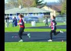 Olivia Sailer maintains her steady pace and holds onto her short lead over her closest pursuer, Pine Island’s Jocasta Adelman, on her way to winning the Women’s 1600-meter run Thursday. Sailer dropped to 3rd place momentarily early in the last lap but quickly regained the lead and hung on to win the race.