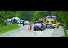 This was the scene on Highway 61 just west of Maple Springs Monday morning following a crash between a car and semi-truck. Emergency personnel work to attend to the injured driver of the car (right-center) while others assist in moving southbound traffic past the scene in this view looking west (highway north).—Photos by Michael Smith