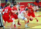 Alma/Pepin’s Caiden Haake finds himself surrounded by a trio of W-K players in the lane in the first half of last week’s home game against the Eagles. Pictured for the Falcons are Liam Blaschko (22), Marcus Meyer and Ryan Wolfe (24). 