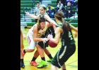 W-K’s Maddie Schmoker (in white) finds the road to the basket quite crowded in action from the second half of Thursday night’s game in La Crescent. 