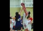 Maddie Schmoker (in white) goes up for a rebound against Catie Stoltman  Saturday during the second half of the Falcons’ win over the Hope Lutheran Patriots. It was the first game in a Boy-Girl doubleheader at Immanuel Lutheran School. 
