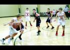 Ryan Wolfe drives the baseline during Saturday’s big victory over the Hope Lutheran Patriots. Wolfe scored eight points, trailing Nik Zell (13), who scored 17 points, and Jackson Gosse (23), who had 15, as well as Marcus Meyer,  who finished with nine points. Zach Kjeseth also had eight for W-K.
