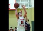 Marcus Meyer puts up a shot in Saturday’s game, going over the top of Hope  Lutheran’s Alec Meinke. The action is from the first half of the 68-35 win, W-K’s fourth of the season and third in the last four games.