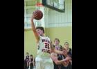 Sophomore Jackson Gosse hauls in a baseline pass from the far side in this first half action Saturday against Hope Lutheran. Gosse had 15 points in the game, second only to Nik Zell’s 17.