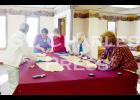 At Faith Lutheran Church, volunteers work together as they cut fabric for Bundles of Love, which recently began meeting in St. Charles. 