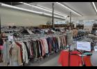 Racks of clothing, shoes and other items stand at the ready inside the spacious store, which began opening its doors to customers in late July.