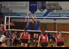 Paige Platter (15) and Haley Poeschel (1) teamed up for a block against an Elmwood attack with Platter getting her fingertips on the ball.