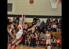E-S junior Jenna Booth took contact from Osseo-Fairchild’s Caitlyn Hughdahl as she took a shot in the paint. Booth scored 10 points for the Lady Cards.