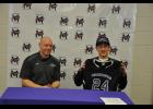 Mondovi’s Collin Evans held up the black and purple jersey of UW-Whitewater during a signing ceremony held Wednesday, Feb. 10. Evans chose coach Jeremy Lade (left) and the national-champion Warhawks men’s wheelchair basketball program over several other schools around the U.S. that also recruited him.