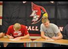 Eleva-Strum seniors Quinn Olson (left) and Bennett Moen each signed off on a National Letter of Intent to play Division 2 college football next season during a signing ceremony at Central High School in conjunction with National Signing Day on Feb. 1.