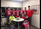 E-S football players and head coach Chad Hanson celebrated graduation with CLIMB youths.