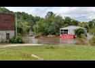 History repeated itself in Gilmanton on Thursday, Aug. 18, as Elk Creek once again flooded the area behind the Gilmanton Feed & Farm Supply store. Debris and flood-soaked possessions residents had already sorted through from the first deluge were again tossed around by the swift current that morning.