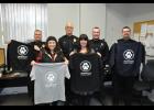 The Mondovi Police Department, working with The Locker Room, has implemented a clothing sale on behalf of its planned K-9 unit. Showing off samples of the t-shirts and sweatshirts are (front) Wendy Buchholz and Bobby Lubinsky, co-owners of The Locker Room, and MPD officers (left to right) Tim Hollister, Chief Scott Smith, Brennan Porter and Adam Julson. The clothing can be custom ordered in a variety of sizes and colors, and each piece features a paw print graphic on the back (pictured). 