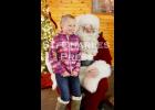 Gracyn Sorenson sits with Santa at the St. Charles Moose Lodge on Saturday afternoon. 
