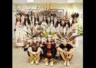 The dancers pose for a photo in their traditional costumes prior to their dance at St. Charles Borromeo Catholic Church on Sunday, December 14th. 
