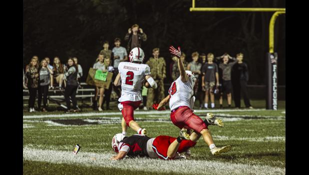No. 2 Reid Hungerholt comes in clutch with a touchdown for the cardinals as the seconds run out in the first half, with Falcon Bryar Ender blocked from a tackle by Hunter Wollenburg, no. 19 of LeRoy-Ostrander/Lyle/Pacelli.