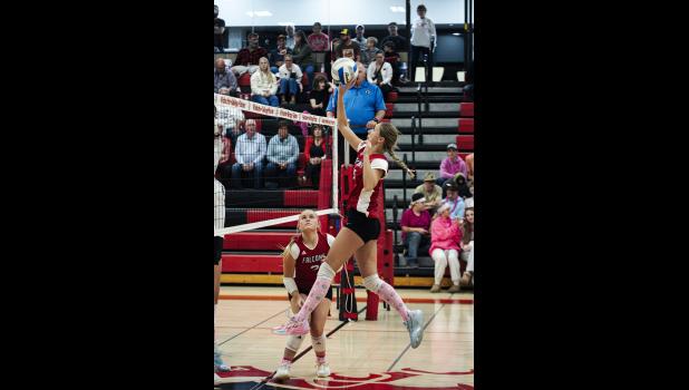Alaina McCann sends a tip over the net.
