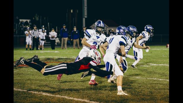 Jax Oxendine leaps in for the tackle against Grand Meadow.