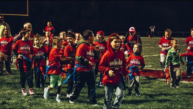 The Little Falcons football team play a game of flag football at halftime.