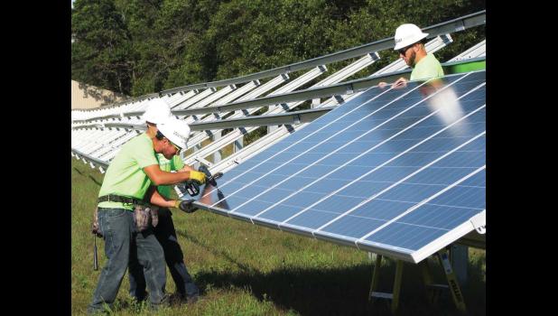 Construction workers from Able Energy placed the first of over 2,800 solar panels as part of Eau Claire Energy Co-op’s MemberSolar project.