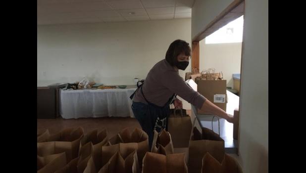 Mickie Theiler distributing the order bags
