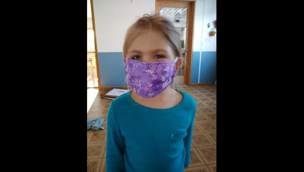 Anna Deml makes a cute model for one of Mom’s completed masks