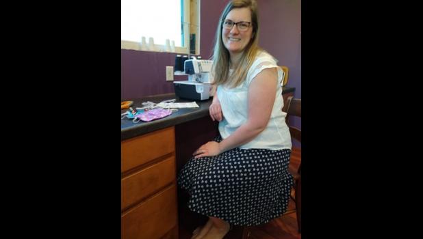 Michelle Deml at home by her sewing machine, is finding out the joys of online teaching.