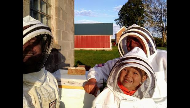 The family that raises bees together, are happy together, as Nick, Christie and Brett get ready to go to the hives