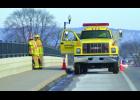A pair of Wabasha firefighters and their truck stood watch at the Hiawatha Drive railroad overpass to keep bystanders from congregating there.