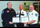 Wabasha Police Officer Dan Metcalf (left) accepts his Life Saving Awards from the Wabasha Police Department and the Wabasha Ambulance Service, represented by Police Chief Joe Stark and Ambulance Service Director John Fox, at last Tuesday afternoon’s City Council meeting. Officer Metcalf saved the life of a 64-year-old St. Charles woman February 19th at a W-K 7th Grade Girls Basketball game here.—Photo by Michael Smith