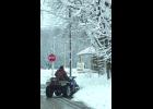 Joe Laska plows snow from his driveway on East 10th Street.
