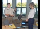 Eagle Center Program Director Scott Mehus shows an eagle’s feather to Lt. Governor Tina Smith as resident eagle Angel watches an eagle soar overhead outside her window Thursday afternoon. 