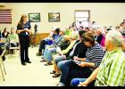 Over 200 people attended an informational hearing, held at Rock Creek Town Hall last Tuesday to voice their opinions about the intent to reissue a Wisconsin Pollutant Discharge Elimination System (WPDES) permit to Cranberry Creek Dairy, LLC. Above, the crowd listens as DNR representative Casey Jones explain the permit process. Laura Berndt photo