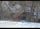 The 2010 Nissan Rogue ended up amid a tangle of trees and branches, one crashing onto its roof, about 30 feet below the highway level.