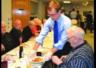 Robert Scanlon serves up pancakes to residents at Saint Elizabeth’s. 