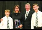 Shannon and her family pose for a picture with her Hall of Fame Award. With her are husband David Larsen and boys, Luke (right) and Layton Larsen.