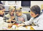 Former students, along with family members, look at items that were buried in the time capsule. Laura Berndt photo